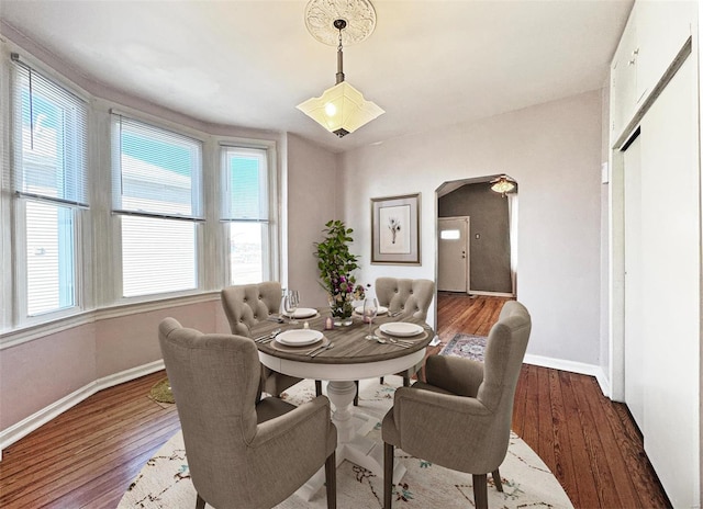 dining space featuring wood-type flooring