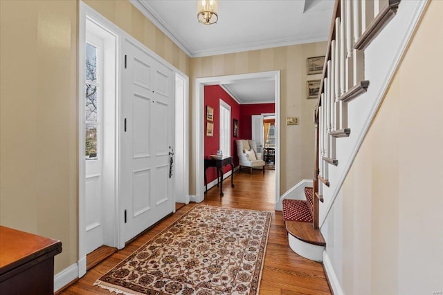 entrance foyer featuring crown molding and hardwood / wood-style flooring