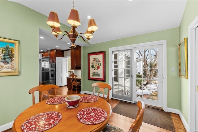 dining room featuring an inviting chandelier and wood-type flooring