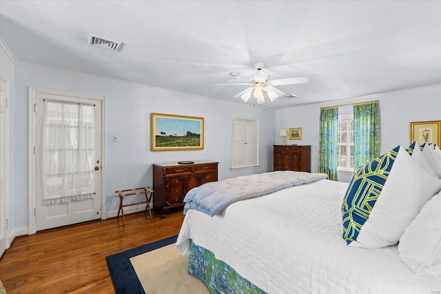 bedroom with wood-type flooring, ceiling fan, and crown molding