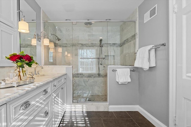 bathroom featuring tile patterned flooring, vanity, and a shower with shower door