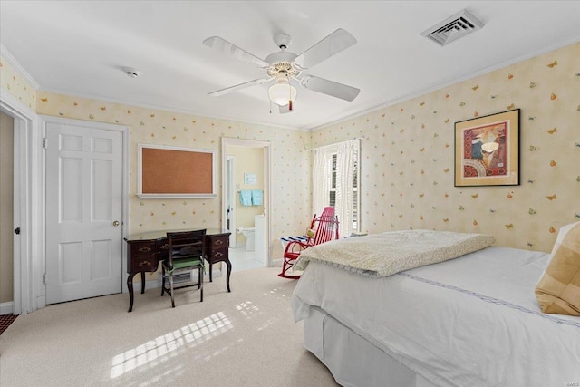 bedroom featuring ceiling fan, ornamental molding, ensuite bathroom, and carpet floors