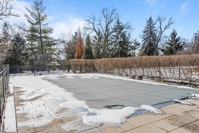 snow covered pool with a patio area