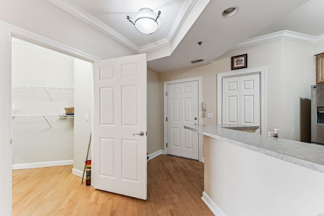 corridor featuring hardwood / wood-style floors and ornamental molding