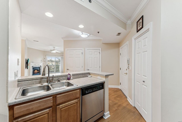 kitchen with ceiling fan, dishwasher, ornamental molding, light hardwood / wood-style flooring, and sink