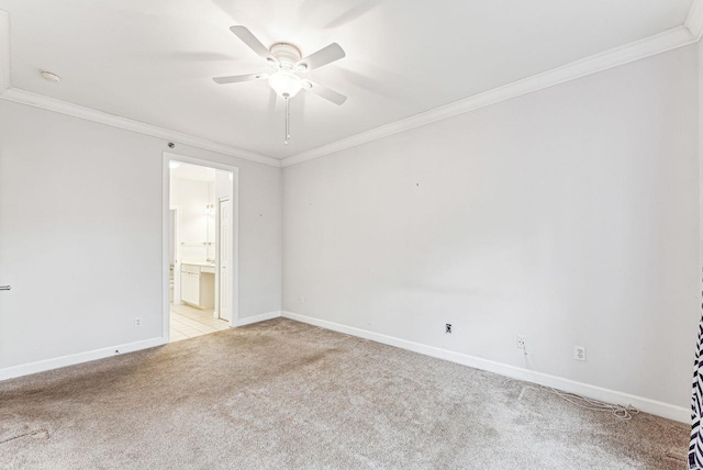 carpeted empty room with ceiling fan and ornamental molding