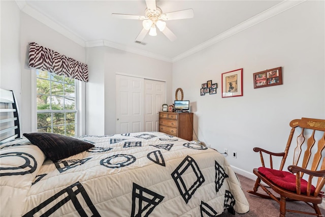 carpeted bedroom featuring ceiling fan, a closet, and crown molding