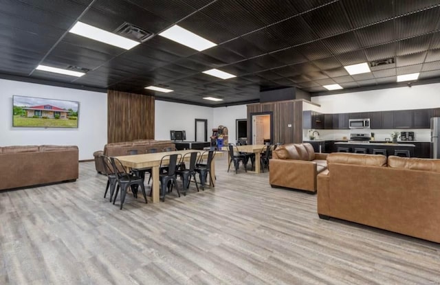 dining space with light hardwood / wood-style floors