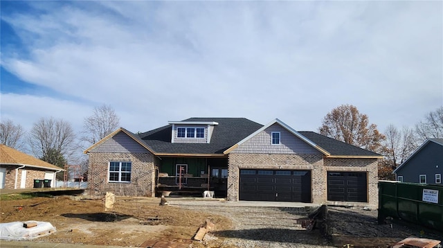 view of front of house featuring covered porch and a garage