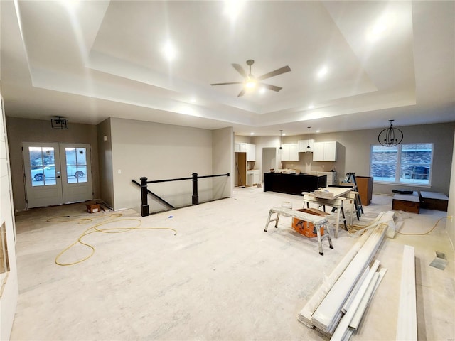 game room featuring french doors, a raised ceiling, and a healthy amount of sunlight