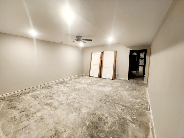 empty room featuring concrete floors and ceiling fan