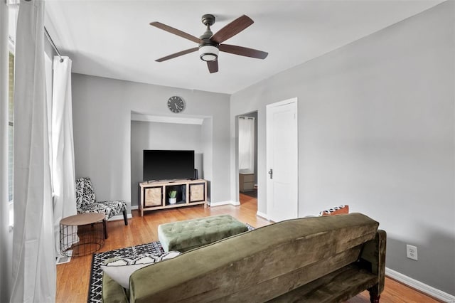 living room with ceiling fan and light hardwood / wood-style floors