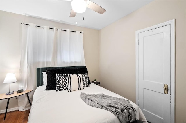 bedroom with wood-type flooring and ceiling fan