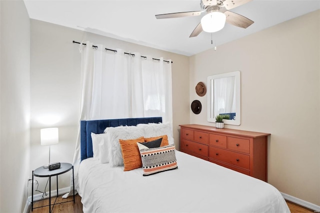 bedroom with hardwood / wood-style flooring and ceiling fan