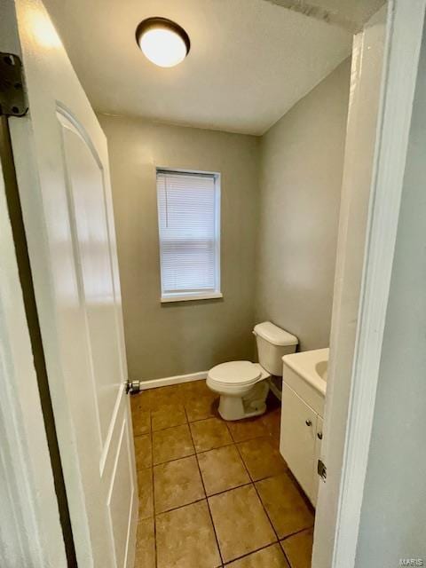 bathroom with tile patterned floors, vanity, and toilet