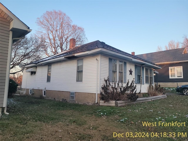 view of side of home featuring a yard