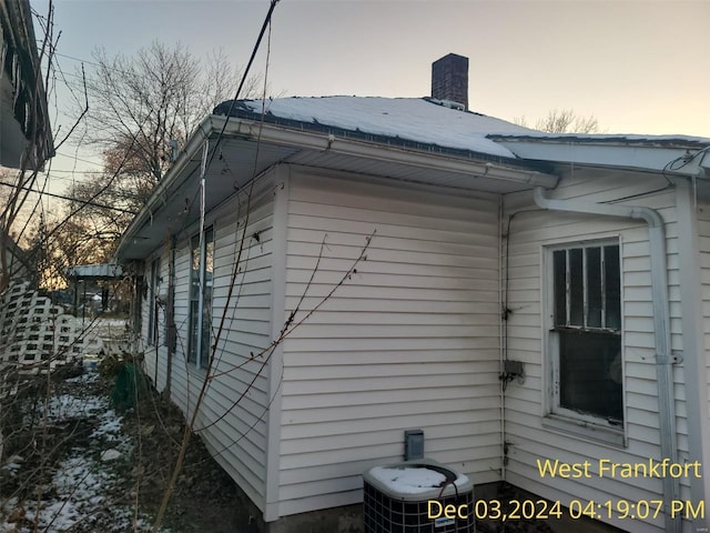 property exterior at dusk featuring central AC