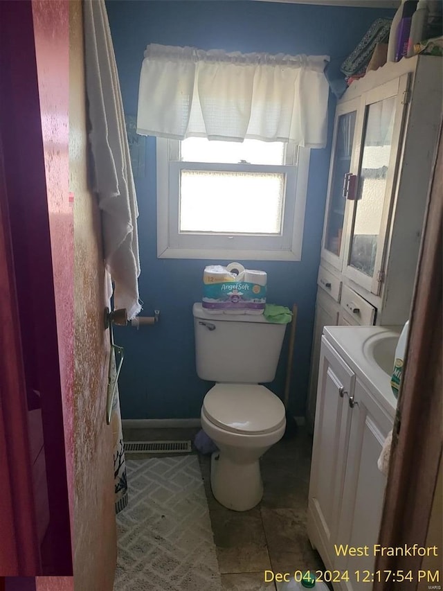 bathroom featuring tile patterned floors, vanity, and toilet