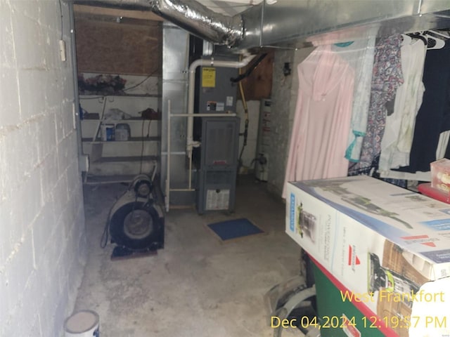 basement with water heater and heating unit