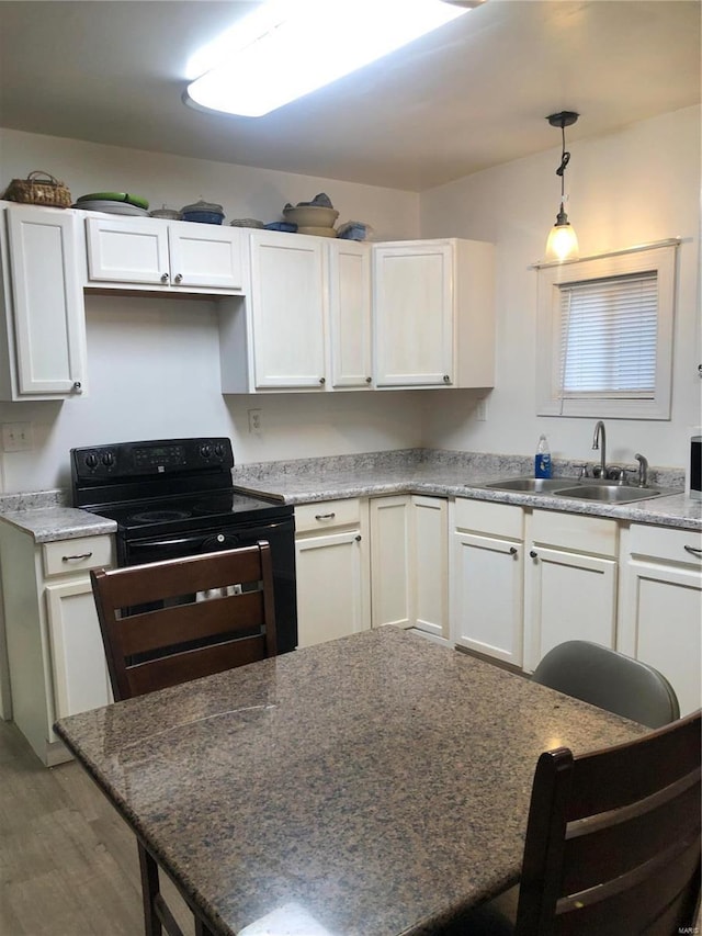 kitchen with electric range, white cabinets, sink, and dark wood-type flooring