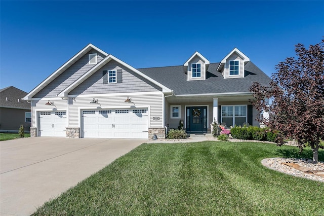 view of front of home with a garage and a front lawn