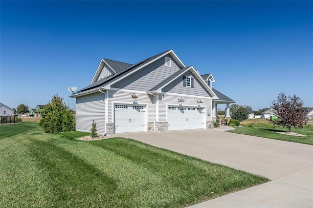 view of home's exterior with a garage and a yard