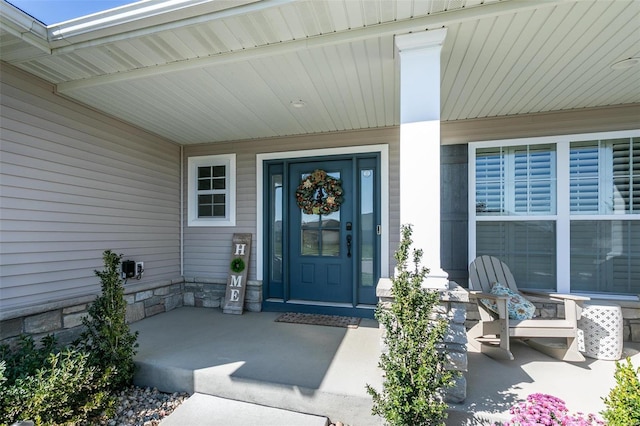 view of exterior entry with a porch