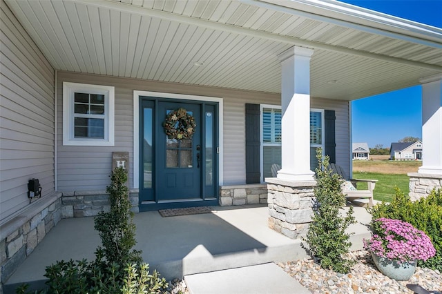 view of exterior entry with covered porch