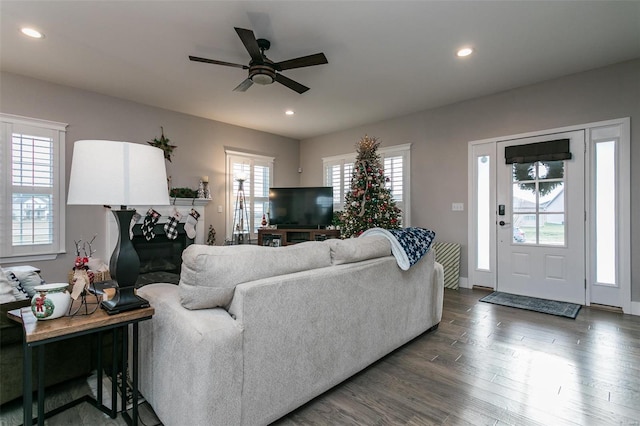 living room with dark wood-type flooring and ceiling fan