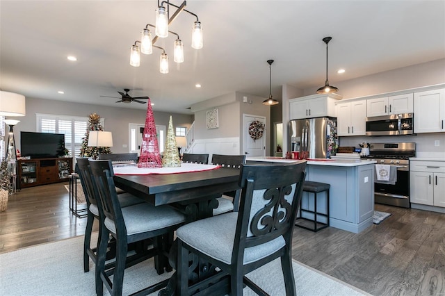 dining room with ceiling fan and dark hardwood / wood-style floors