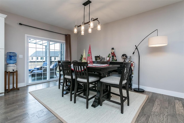 dining space with dark wood-type flooring