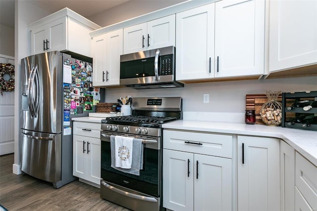 kitchen featuring stainless steel appliances, dark hardwood / wood-style floors, and white cabinets