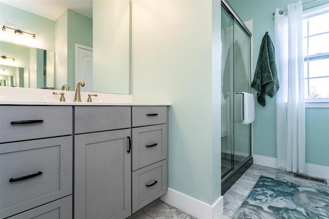 bathroom featuring vanity and an enclosed shower