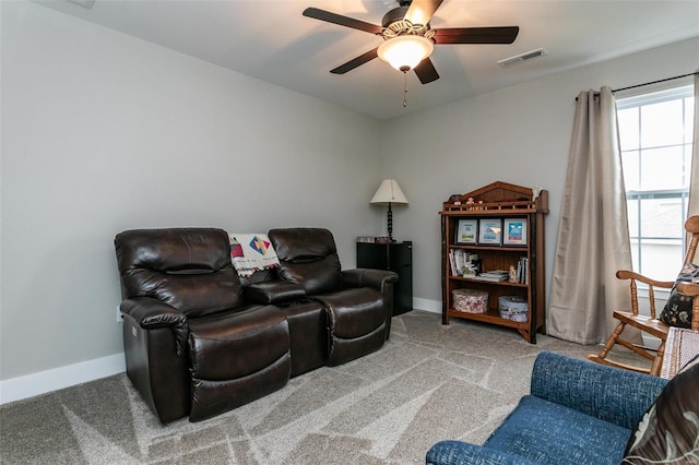 home theater room featuring ceiling fan and carpet