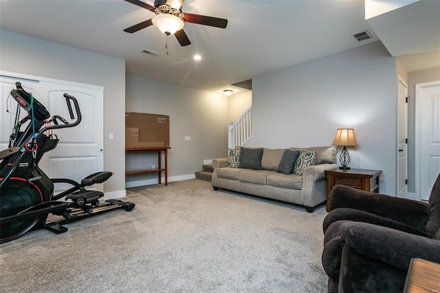 carpeted living room with ceiling fan