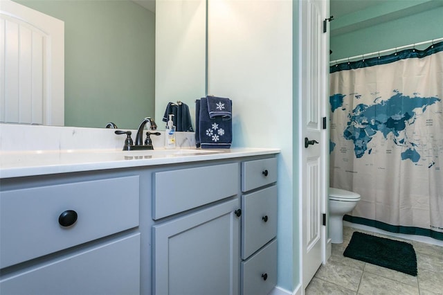 bathroom featuring vanity, tile patterned floors, and toilet