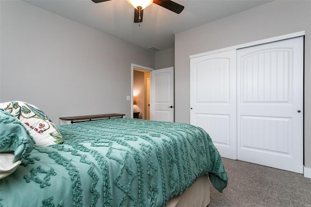 carpeted bedroom featuring ceiling fan and a closet