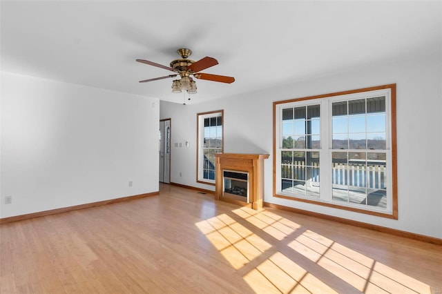 unfurnished living room featuring ceiling fan and light wood-type flooring