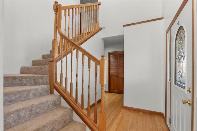 stairs featuring hardwood / wood-style floors