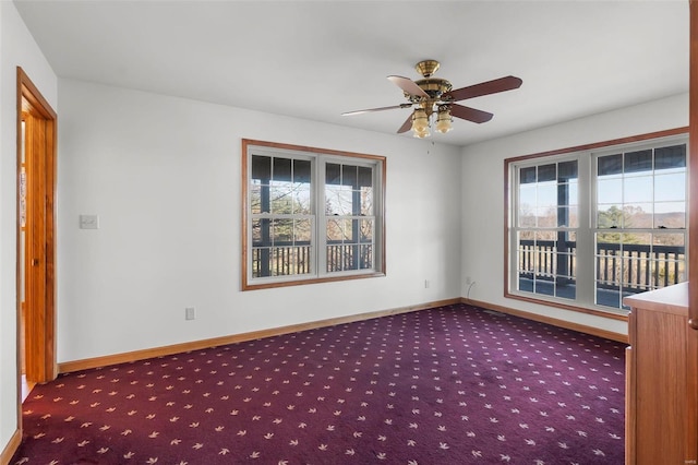 empty room with ceiling fan, carpet floors, and a wealth of natural light