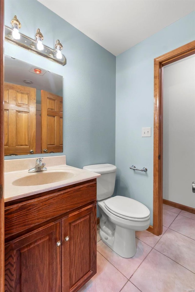 bathroom with tile patterned floors, vanity, and toilet