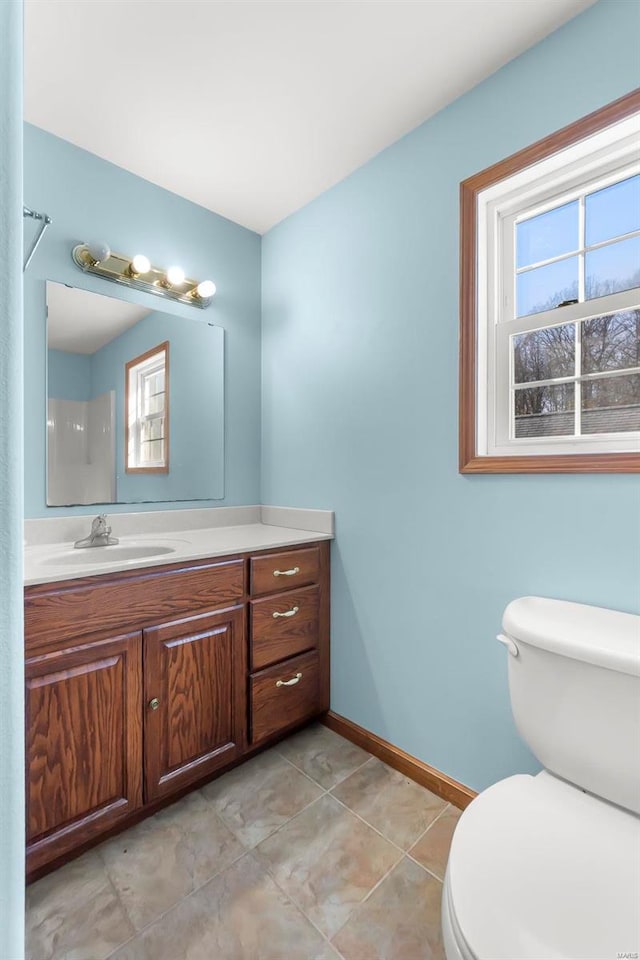 bathroom with tile patterned flooring, vanity, and toilet