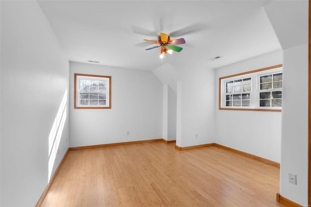 bonus room with ceiling fan, light hardwood / wood-style flooring, and vaulted ceiling