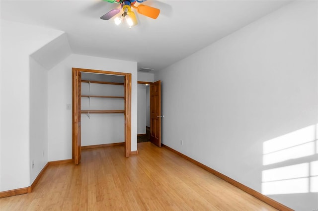 unfurnished bedroom featuring ceiling fan, a closet, and light wood-type flooring