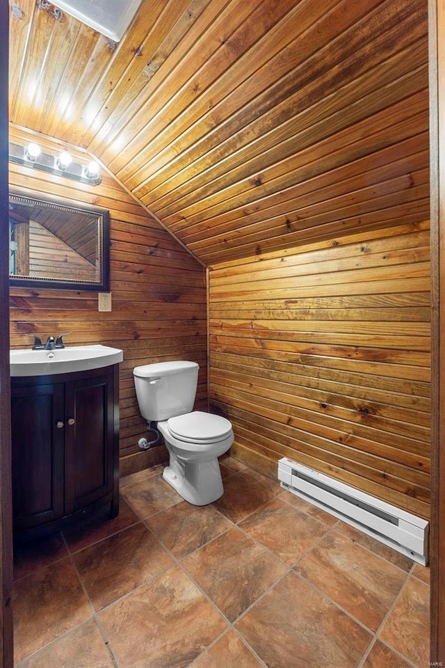 bathroom with lofted ceiling, wooden ceiling, wooden walls, toilet, and baseboard heating