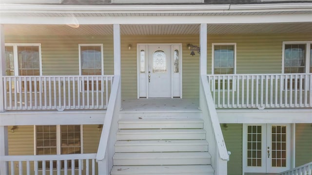 entrance to property with covered porch and french doors