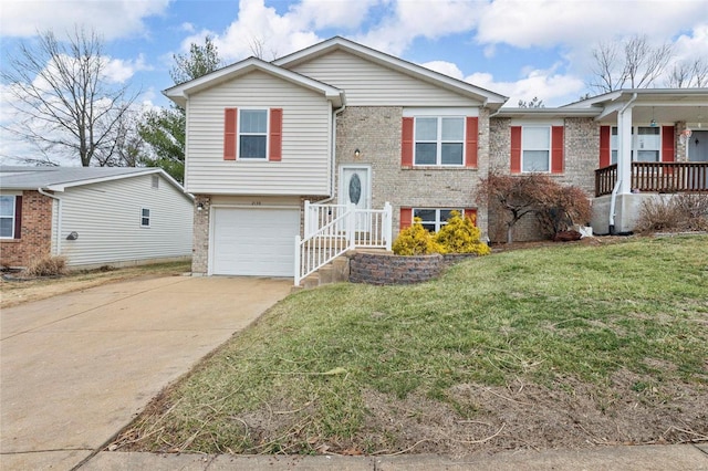 view of front of house with a front yard, concrete driveway, brick siding, and an attached garage