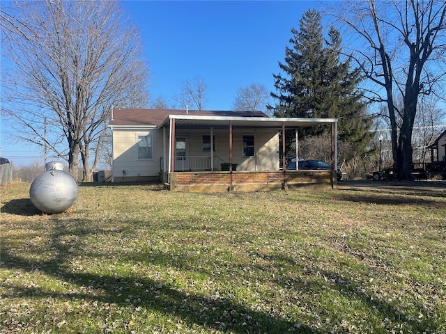 rear view of house with central AC, a yard, and covered porch