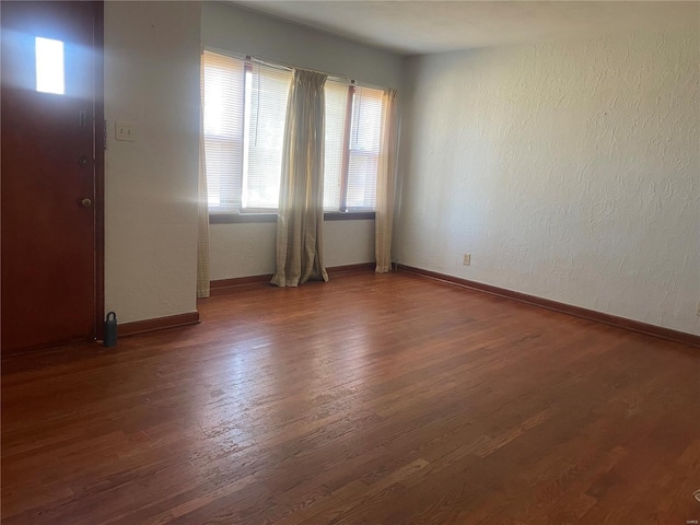 entryway with dark hardwood / wood-style flooring