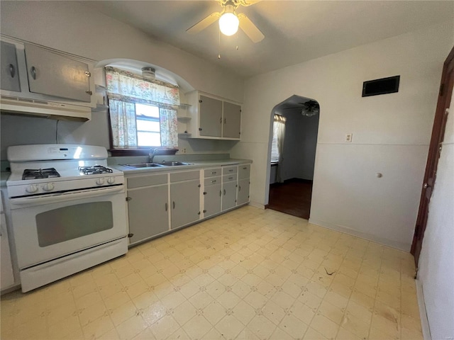 kitchen featuring ceiling fan, sink, white range with gas stovetop, extractor fan, and gray cabinets